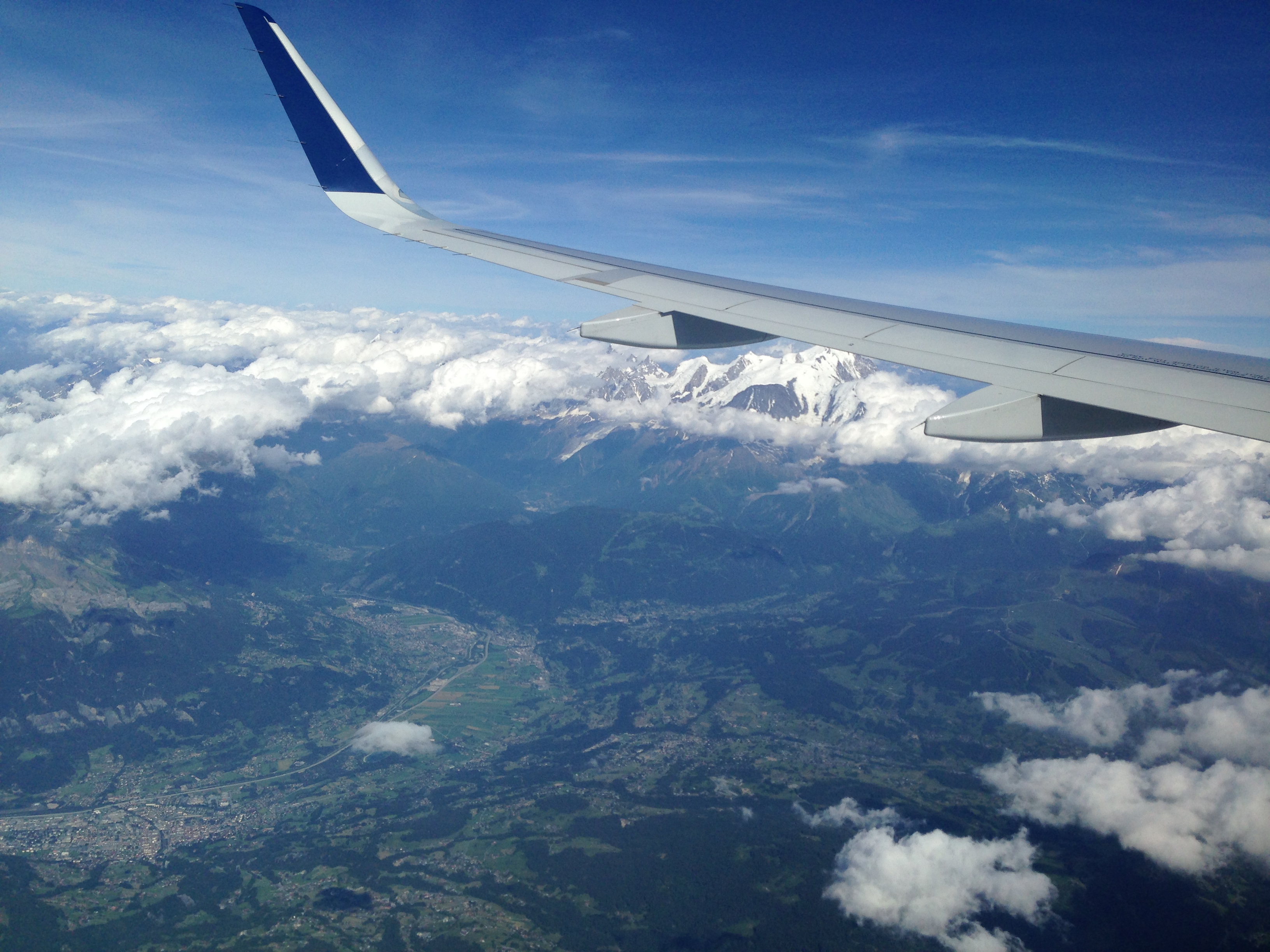 les Alpes dans les nuages derrière l'aile de l'avion